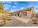 Exterior backyard features a covered patio, gravel landscaping, and block wall under a blue sky at 6128 Forest Pony Ave, Las Vegas, NV 89122