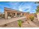 View of the backyard featuring a covered patio, gravel landscaping, and a block wall at 6128 Forest Pony Ave, Las Vegas, NV 89122