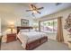 Inviting bedroom with a ceiling fan, window, plush carpet and a dark wood bedroom set at 6128 Forest Pony Ave, Las Vegas, NV 89122