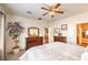 Bedroom featuring a ceiling fan, carpeted floors, and a glimpse of a nearby living area at 6128 Forest Pony Ave, Las Vegas, NV 89122