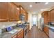 Kitchen with wood flooring, stainless steel appliances, granite countertops and wooden cabinetry at 6128 Forest Pony Ave, Las Vegas, NV 89122