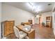 Bright room with hardwood floors and track lighting, featuring sewing machine and adjacent bathroom at 6128 Forest Pony Ave, Las Vegas, NV 89122