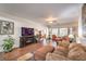 Living room with a ceiling fan, TV, and plush furniture at 6128 Forest Pony Ave, Las Vegas, NV 89122