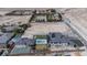A luxury home features a pool, tennis court, desert landscaping, and ample land for future expansion at 6265 Iron Mountain Rd, Las Vegas, NV 89131