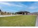 Expansive backyard with a sparkling pool, lush lawn, and ample space for outdoor activities at 6265 Iron Mountain Rd, Las Vegas, NV 89131