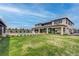 Expansive backyard with lush lawn, landscaping, and a modern home design at 6265 Iron Mountain Rd, Las Vegas, NV 89131