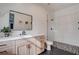 Bright bathroom with a modern vanity, glass-enclosed shower, and patterned tile floor at 6265 Iron Mountain Rd, Las Vegas, NV 89131