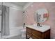 Stylish bathroom featuring a modern vanity, tile backsplash, and tub with shower at 6265 Iron Mountain Rd, Las Vegas, NV 89131
