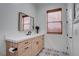 Modern bathroom with wood cabinets, patterned floor tiles, and a stylish mirror at 6265 Iron Mountain Rd, Las Vegas, NV 89131