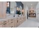 This bathroom features light wood cabinets, dual sinks, and tile floors at 6265 Iron Mountain Rd, Las Vegas, NV 89131