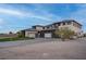Modern luxury home with three-car garage and desert landscaping at 6265 Iron Mountain Rd, Las Vegas, NV 89131