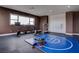Home gym with exercise equipment, including a rowing machine, treadmill, and wrestling mat at 6265 Iron Mountain Rd, Las Vegas, NV 89131