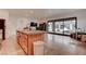 Modern kitchen island with granite countertops and a view of the backyard and pool at 6265 Iron Mountain Rd, Las Vegas, NV 89131