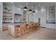 Bright kitchen featuring custom cabinetry, a large island with bar seating, and hardwood flooring at 6265 Iron Mountain Rd, Las Vegas, NV 89131
