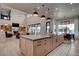 Well-lit kitchen with hardwood floors, center island, and views of the living room at 6265 Iron Mountain Rd, Las Vegas, NV 89131