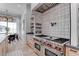 Gourmet kitchen boasting a stainless steel range with a tile backsplash and custom cabinetry at 6265 Iron Mountain Rd, Las Vegas, NV 89131