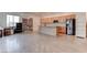 Kitchenette with stainless steel appliances and natural wood cabinets, ideal for casual dining at 6265 Iron Mountain Rd, Las Vegas, NV 89131
