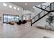 Bright, airy living room with hardwood floors, modern staircase, and large windows at 6265 Iron Mountain Rd, Las Vegas, NV 89131