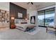 This main bedroom features neutral tones, a decorative accent wall, and a sliding glass door to the backyard at 6265 Iron Mountain Rd, Las Vegas, NV 89131