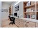 This office features built-in shelves and cabinets, a desk, and light wood floors at 6265 Iron Mountain Rd, Las Vegas, NV 89131