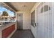 Exterior view of a condo balcony featuring painted stucco and a security door at 6808 Elm Creek Dr # 203, Las Vegas, NV 89108