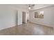 Bright bedroom features a window, ceiling fan and neutral flooring at 6808 Elm Creek Dr # 203, Las Vegas, NV 89108