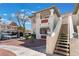 Attractive condo building with stairs, landscaping, and assigned covered parking for residents and guests at 6808 Elm Creek Dr # 203, Las Vegas, NV 89108
