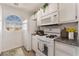 Clean kitchen with white appliances, granite countertops, and natural light at 6808 Elm Creek Dr # 203, Las Vegas, NV 89108