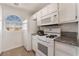 Bright kitchen with white appliances, granite countertops, and natural light at 6808 Elm Creek Dr # 203, Las Vegas, NV 89108