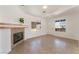 Bright living room featuring tile floors, neutral walls, a fireplace, and two large windows at 6808 Elm Creek Dr # 203, Las Vegas, NV 89108