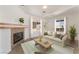 Cozy living room featuring a fireplace, neutral sofa, and bright windows at 6808 Elm Creek Dr # 203, Las Vegas, NV 89108