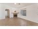 Well-lit living room features tile floors, a fireplace, and a bright window at 6808 Elm Creek Dr # 203, Las Vegas, NV 89108