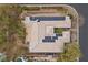 Aerial shot of a home with solar panels, a backyard pool, and desert landscaping at 7288 Olsen Farm St, Las Vegas, NV 89131