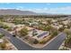 Aerial view showing a neighborhood with desert landscaping, solar panels, and mountain views, depicting modern, sustainable living at 7288 Olsen Farm St, Las Vegas, NV 89131