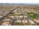 Panoramic aerial shot shows a well-planned community featuring tree-lined streets, landscaped yards, and diverse home styles at 7288 Olsen Farm St, Las Vegas, NV 89131