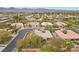 Expansive aerial view of a residential neighborhood featuring single-Gathering homes, mature landscaping, and mountain views in the distance at 7288 Olsen Farm St, Las Vegas, NV 89131