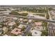 An aerial view showcases homes near green space and roads, highlighting community amenities and easy access in this residential area at 7288 Olsen Farm St, Las Vegas, NV 89131