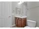 Charming bathroom featuring a wood vanity, toilet, and vanity mirror at 7288 Olsen Farm St, Las Vegas, NV 89131