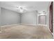 Open, airy bedroom with neutral walls, carpet, ceiling fan, and natural light at 7288 Olsen Farm St, Las Vegas, NV 89131