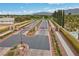 Gated community entrance with landscaped median, providing security and aesthetic appeal at 7288 Olsen Farm St, Las Vegas, NV 89131