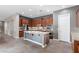 Open kitchen featuring stainless steel appliances, a large island with sink and neutral countertops at 7288 Olsen Farm St, Las Vegas, NV 89131