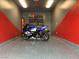 Well-organized garage with a motorcycle, shelving, and epoxy floors, suitable for a hobbyist at 7904 Greycrest Ct # 104, Las Vegas, NV 89145
