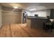 Open-concept kitchen featuring white cabinets, stainless steel appliances, and a breakfast bar with seating at 7904 Greycrest Ct # 104, Las Vegas, NV 89145