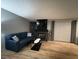 Inviting living room with a blue sofa, sleek coffee table, and a cozy fireplace under a mounted TV at 7904 Greycrest Ct # 104, Las Vegas, NV 89145
