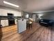 Cozy living room featuring hardwood floors, a modern kitchen with stainless steel appliances, and stylish furnishings at 7904 Greycrest Ct # 104, Las Vegas, NV 89145
