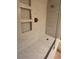 Luxurious shower with mosaic tile flooring and sleek fixtures at 7904 Greycrest Ct # 104, Las Vegas, NV 89145