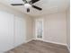 This cozy bedroom features wood-look flooring, a ceiling fan, and a closet with sliding doors at 8008 Draco Cir # 201, Las Vegas, NV 89128