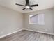 Bedroom with modern wood floors, ceiling fan, and neutral walls at 8008 Draco Cir # 201, Las Vegas, NV 89128