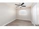 Bedroom featuring wood floors, a ceiling fan, and ample natural light at 8008 Draco Cir # 201, Las Vegas, NV 89128