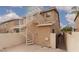 A tan home features a metal spiral staircase leading to the upper level patio at 8008 Draco Cir # 201, Las Vegas, NV 89128